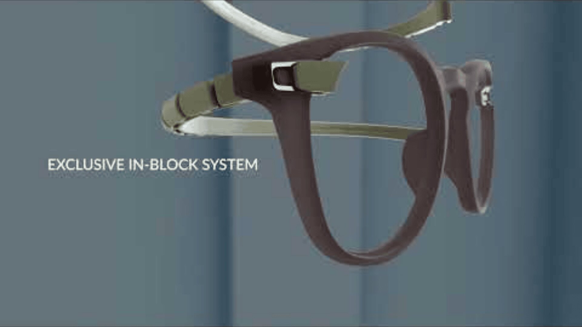 Against a blurred blue background, glasses with a modern frame and exclusive in-block system can be seen.