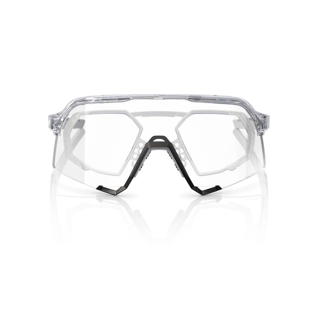 Transparent safety spectacles with black bridge and nose piece on a white background, forward-facing. The design is characterized by angular lines and transparent, wrap-around lenses to protect the eyes.