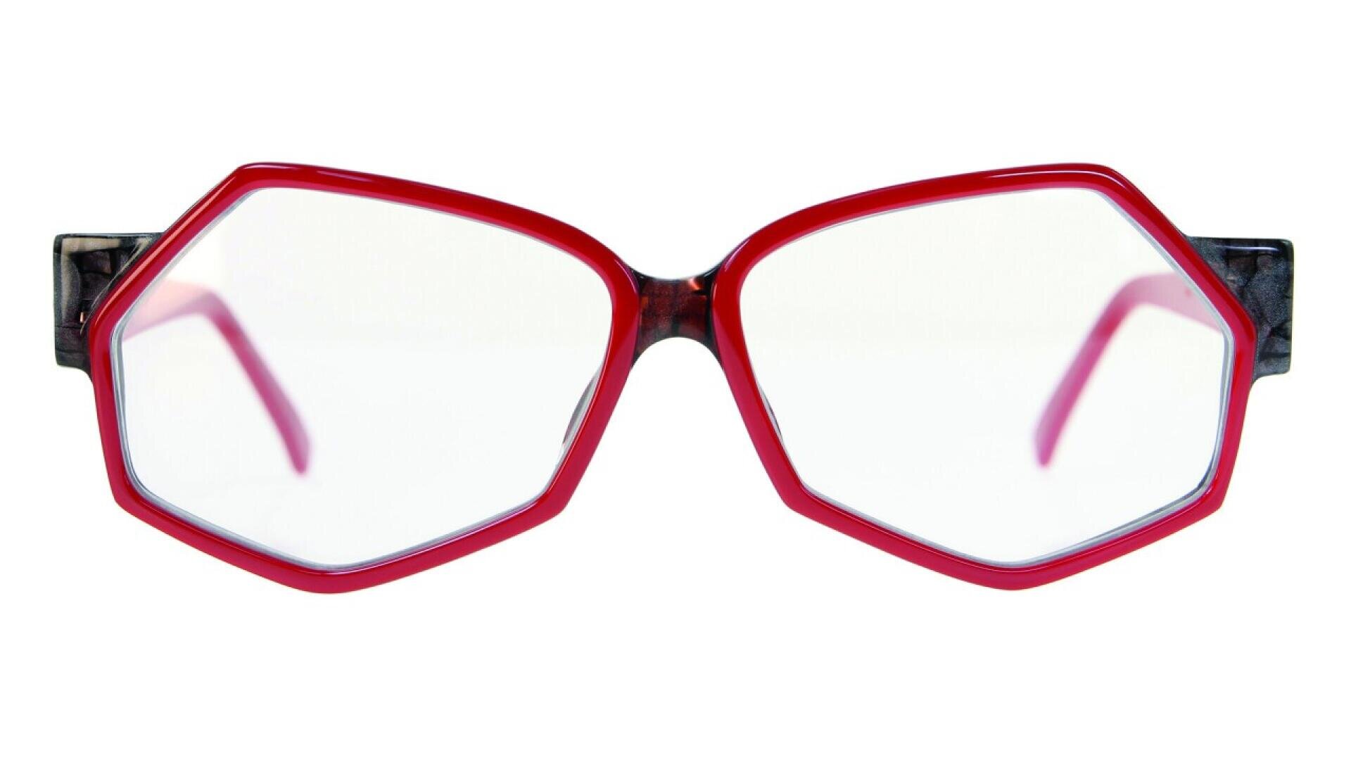 A pair of eyeglasses with bright red, geometric, hexagonal frames and clear lenses, shown against a white background.