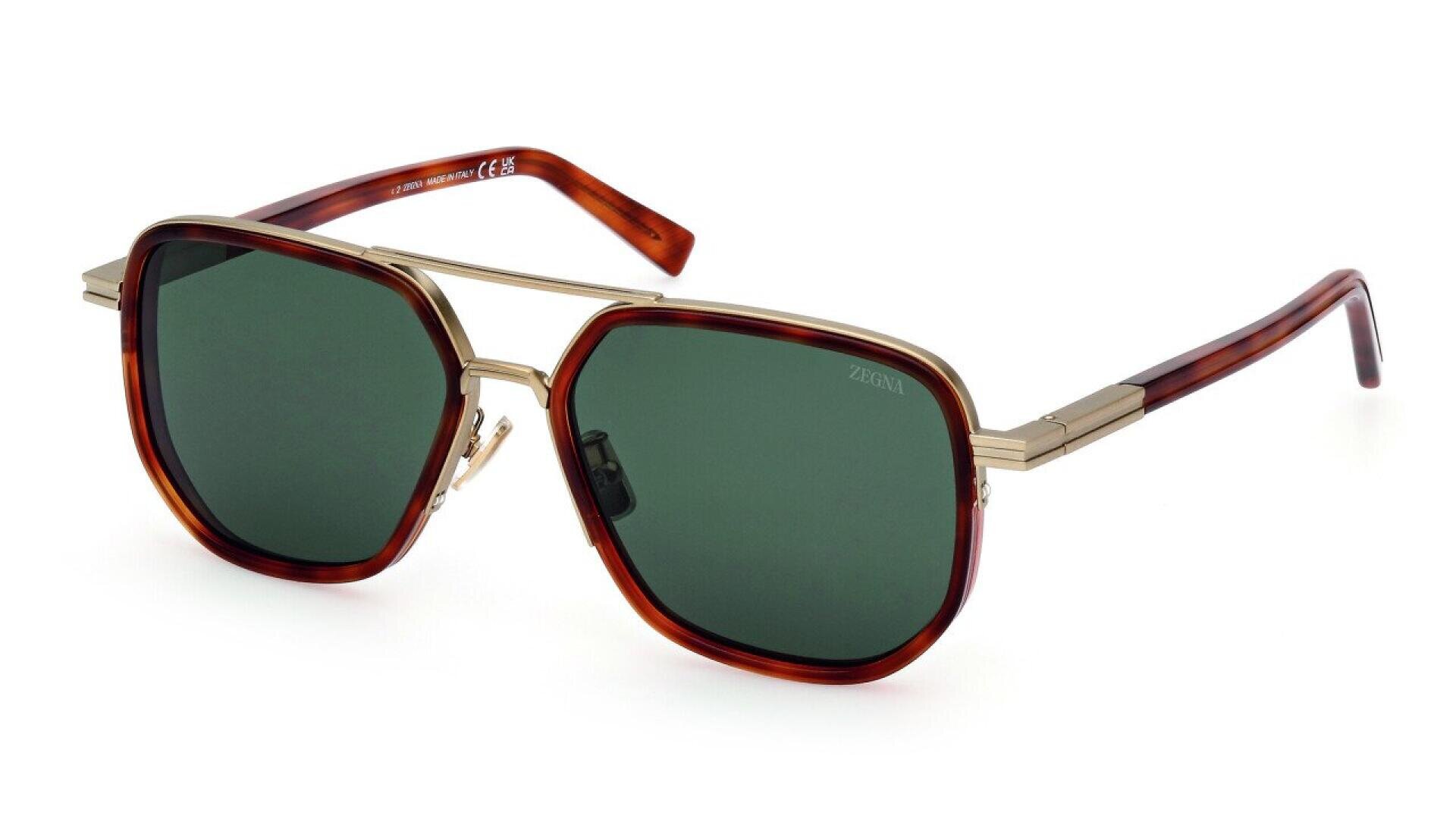 A pair of sunglasses with green-tinted lenses, gold metal frame, and brown tortoiseshell arms, displayed on a white background.