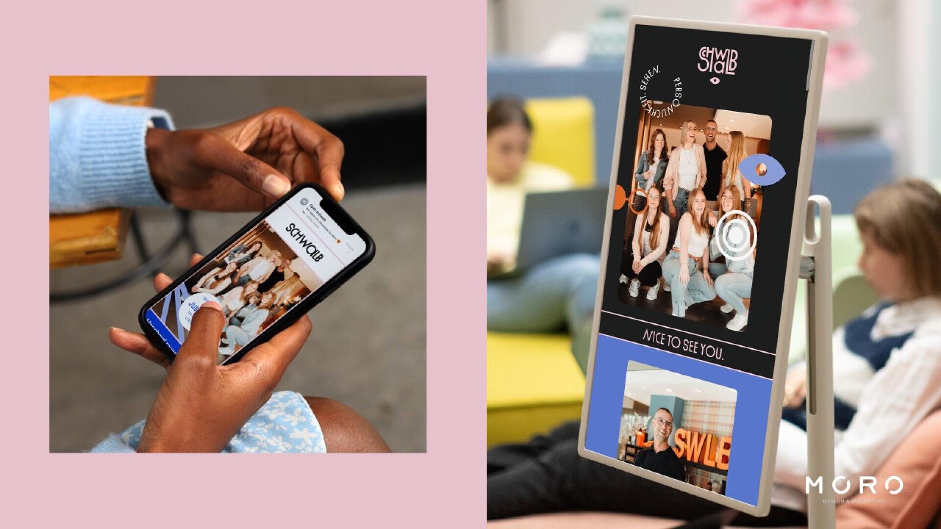 A person uses a smartphone with a group photo on the screen, while nearby a digital kiosk displays the same group photo. Two people sit on a couch in the background, one looking at the kiosk.