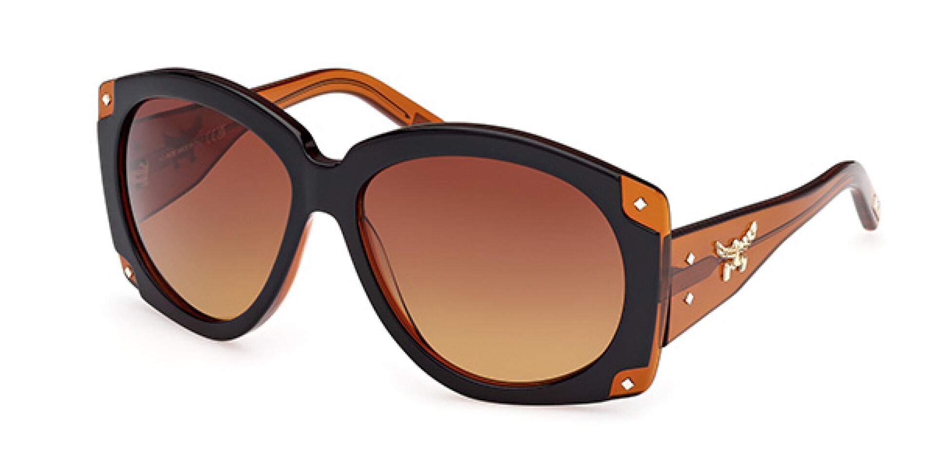 Übergroße Sonnenbrille mit dickem schwarz-braunem Rahmen, braunen Verlaufsgläsern, goldenen Nietenakzenten an den Ecken und einem kleinen goldenen Zieremblem an den Bügeln.