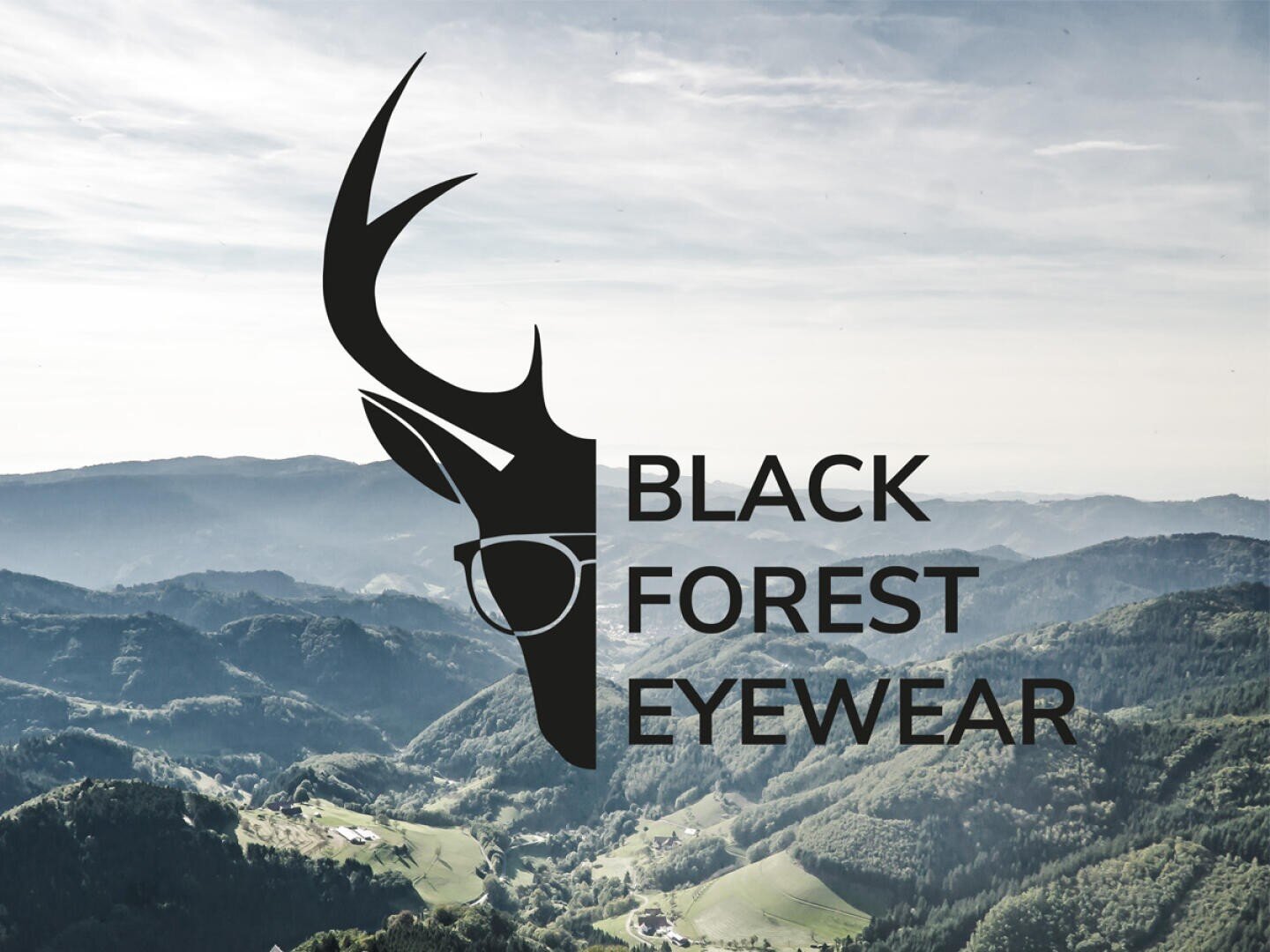 A logo with a black deer head wearing glasses and the text BLACK FOREST EYEWEAR is overlaid on a scenic, mountainous forest landscape with hills and villages below.