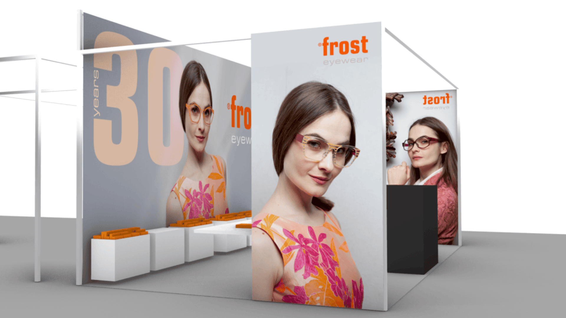 A modern trade show booth for Frost Eyewear features large images of a woman wearing stylish glasses, orange accents, and displays of eyewear products on white shelves. The booth celebrates 30 years.