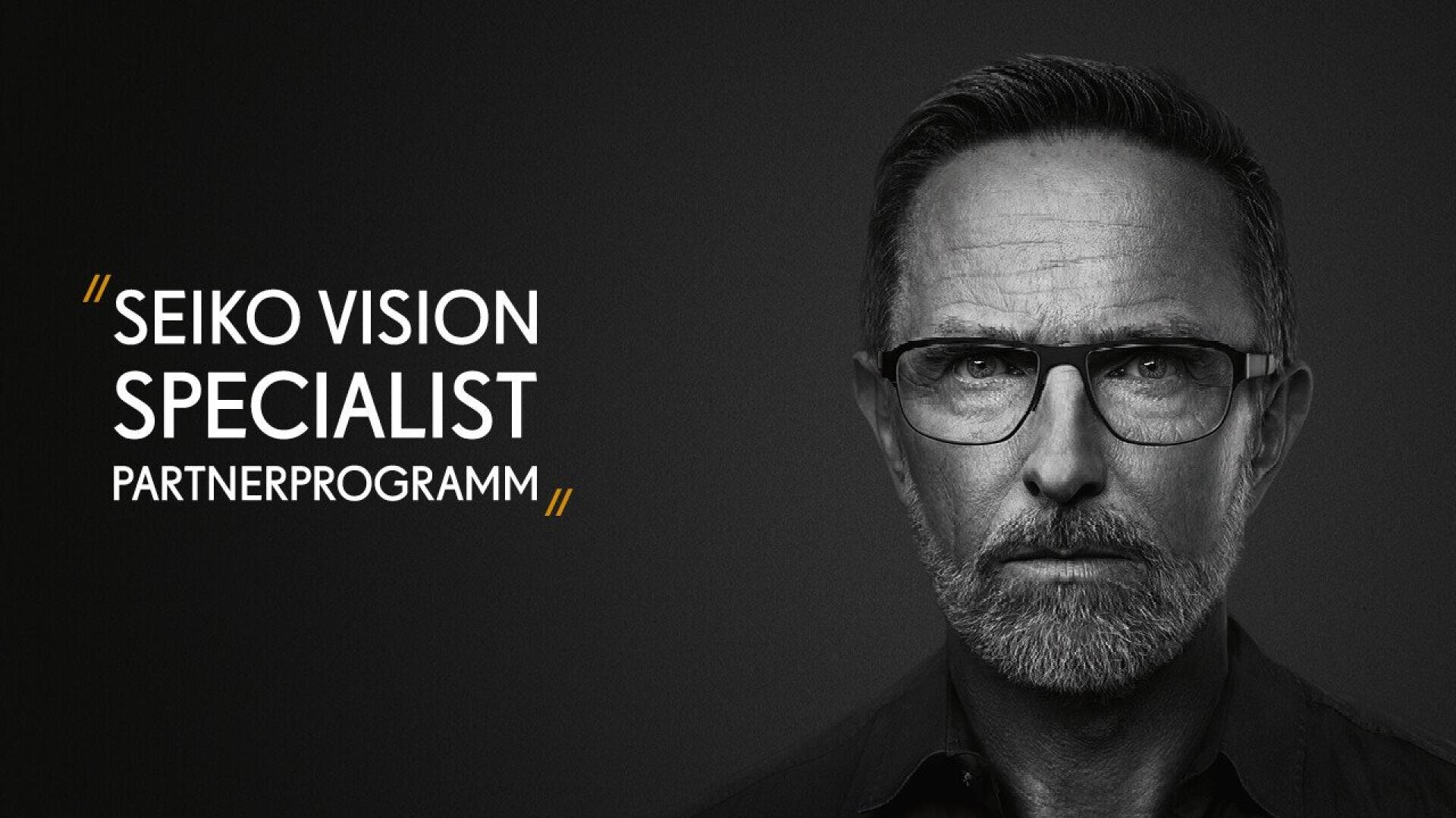 A serious-looking man with glasses and a beard is shown in black and white. To his left, text reads: SEIKO VISION SPECIALIST PARTNERPROGRAMM with gold quotation marks.