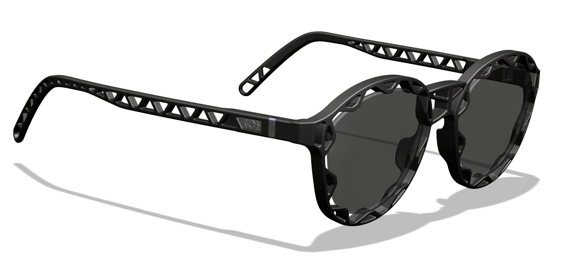 Schwarze Sonnenbrille mit runden, dunklen Gläsern und einzigartigen geometrischen Ausschnitten entlang der Bügel und des Rahmens, die einen Schatten auf eine weiße Fläche werfen.