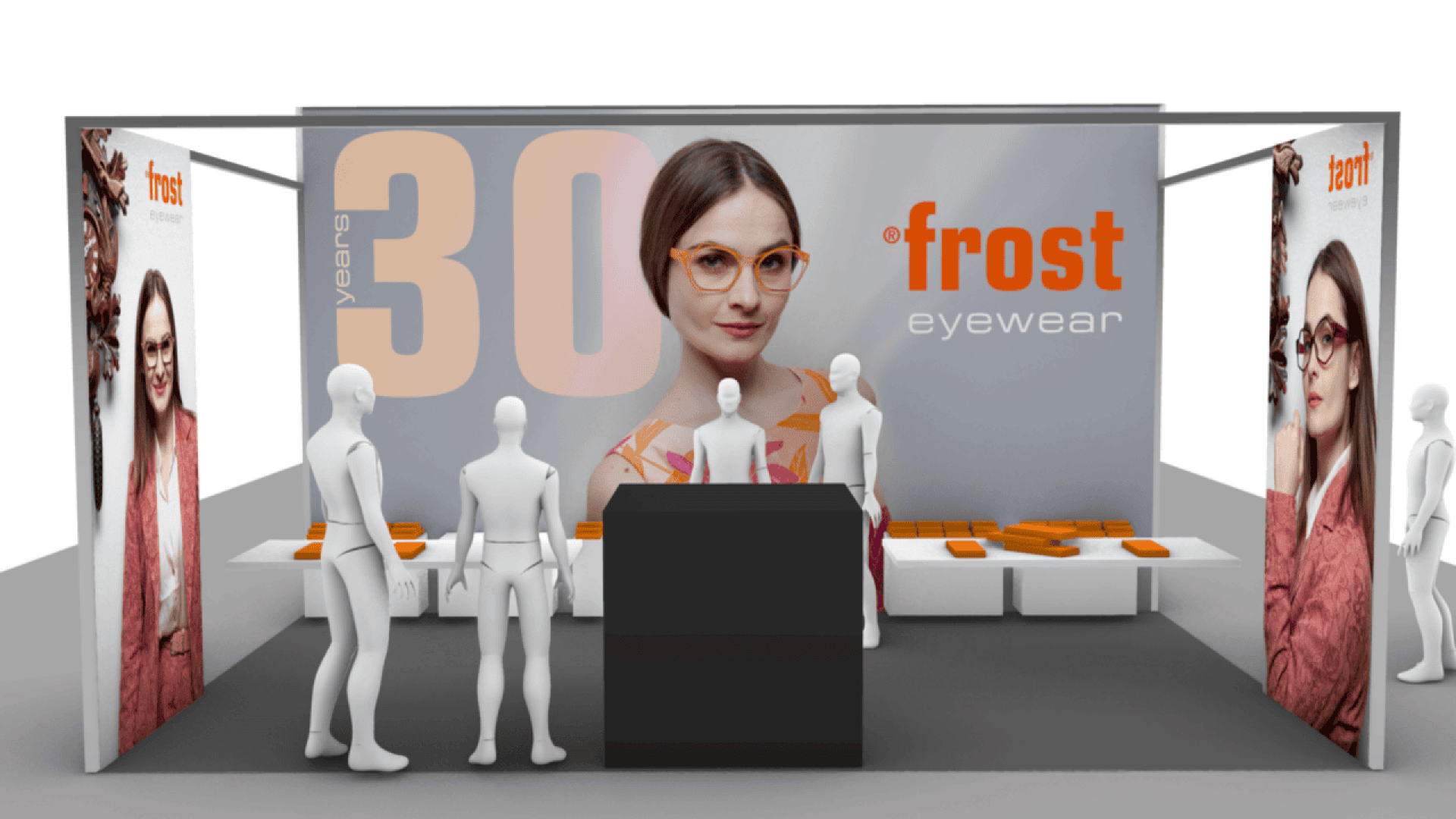 Exhibition booth for Frost Eyewear with mannequins, display tables, and large posters featuring models in eyeglasses. The backdrop reads “30 years” and “Frost Eyewear.” Orange cases are displayed on tables.